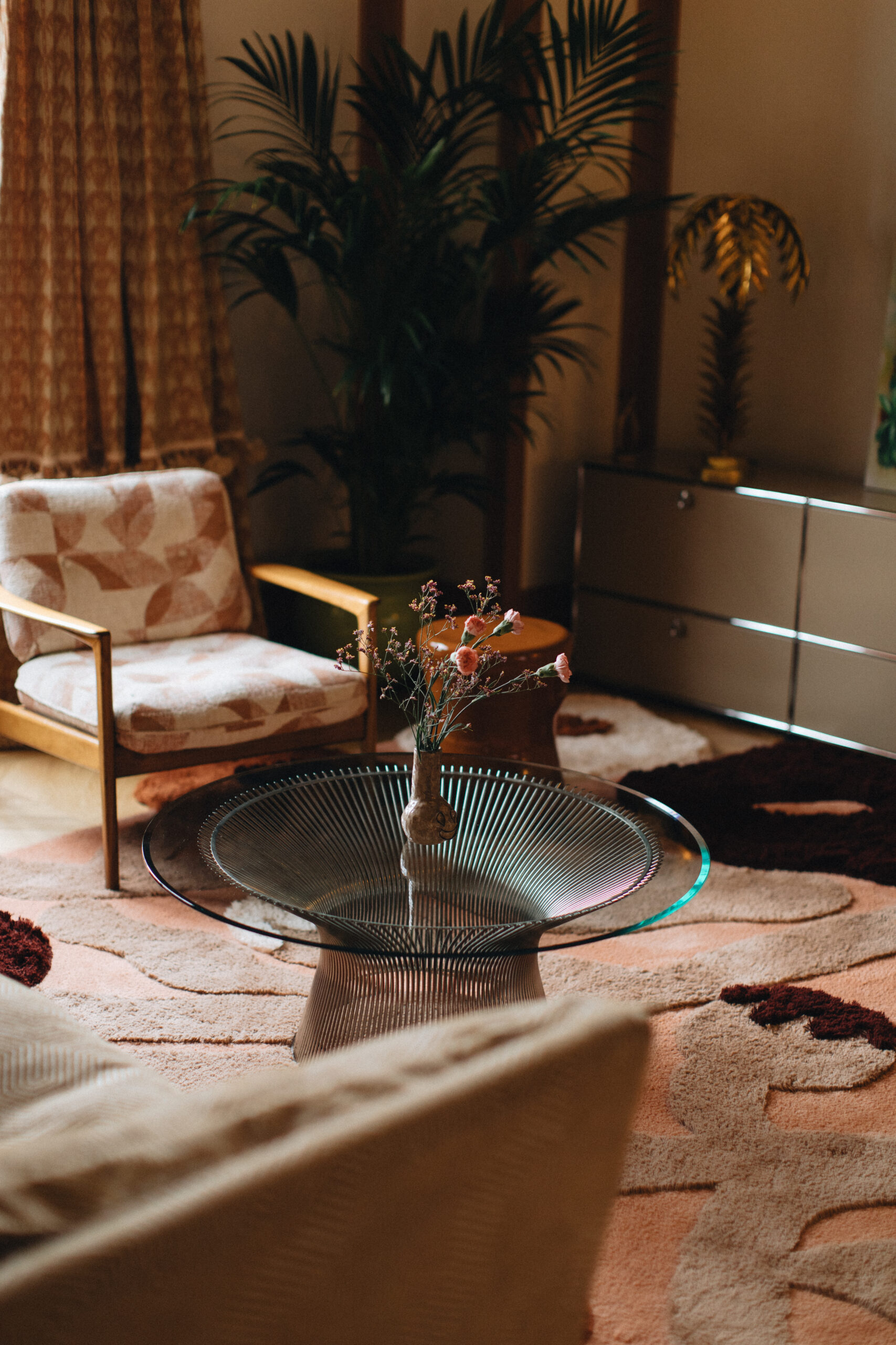 Rug with poppies in terracotta color scheme in a bohemian interior. Terracotta, faded terracotta, cream, dark maroon, sand.