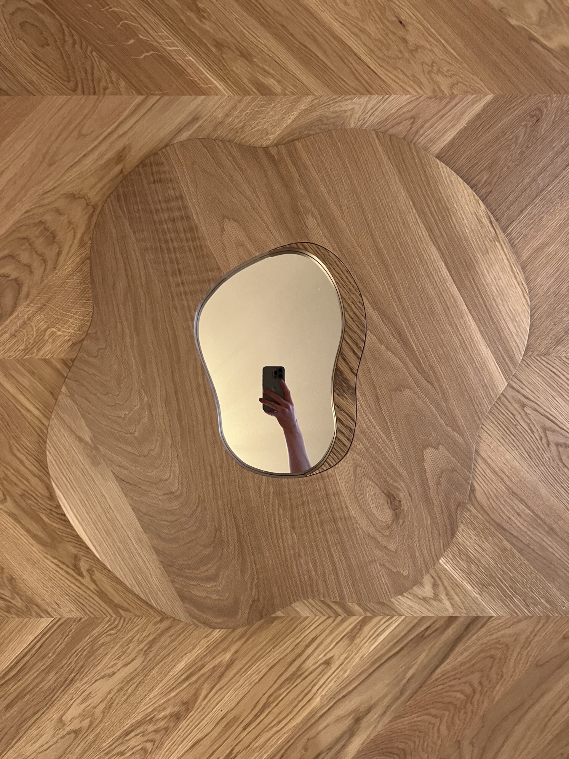 Poppy mirror in solid oak on chevron oak floor