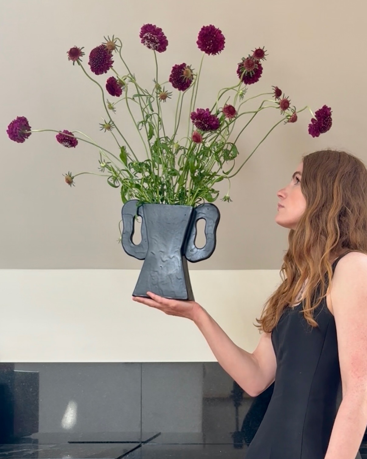 Madelen Möllard_Black Poppy Vase Madelen Möllard holding a sculptural vase in her design