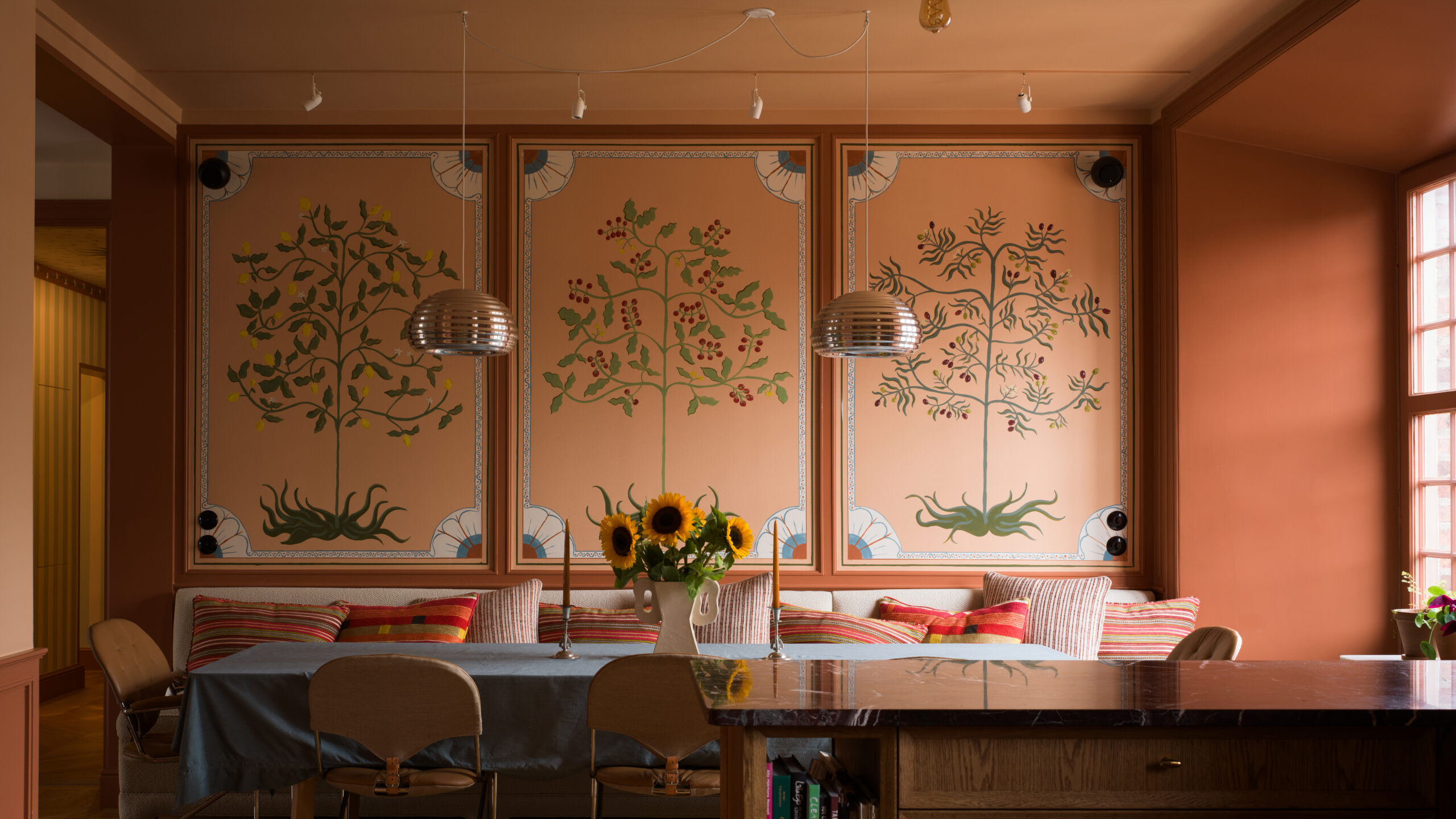 Hand-painted interior — Madelen Möllard Interior with hand-painted botanical wall panels by Madelen Möllard in warm terracotta tones.